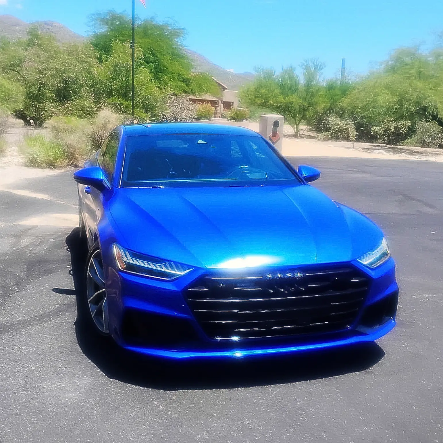 Blue Audi A7 with a ceramic-coated finish in the desert