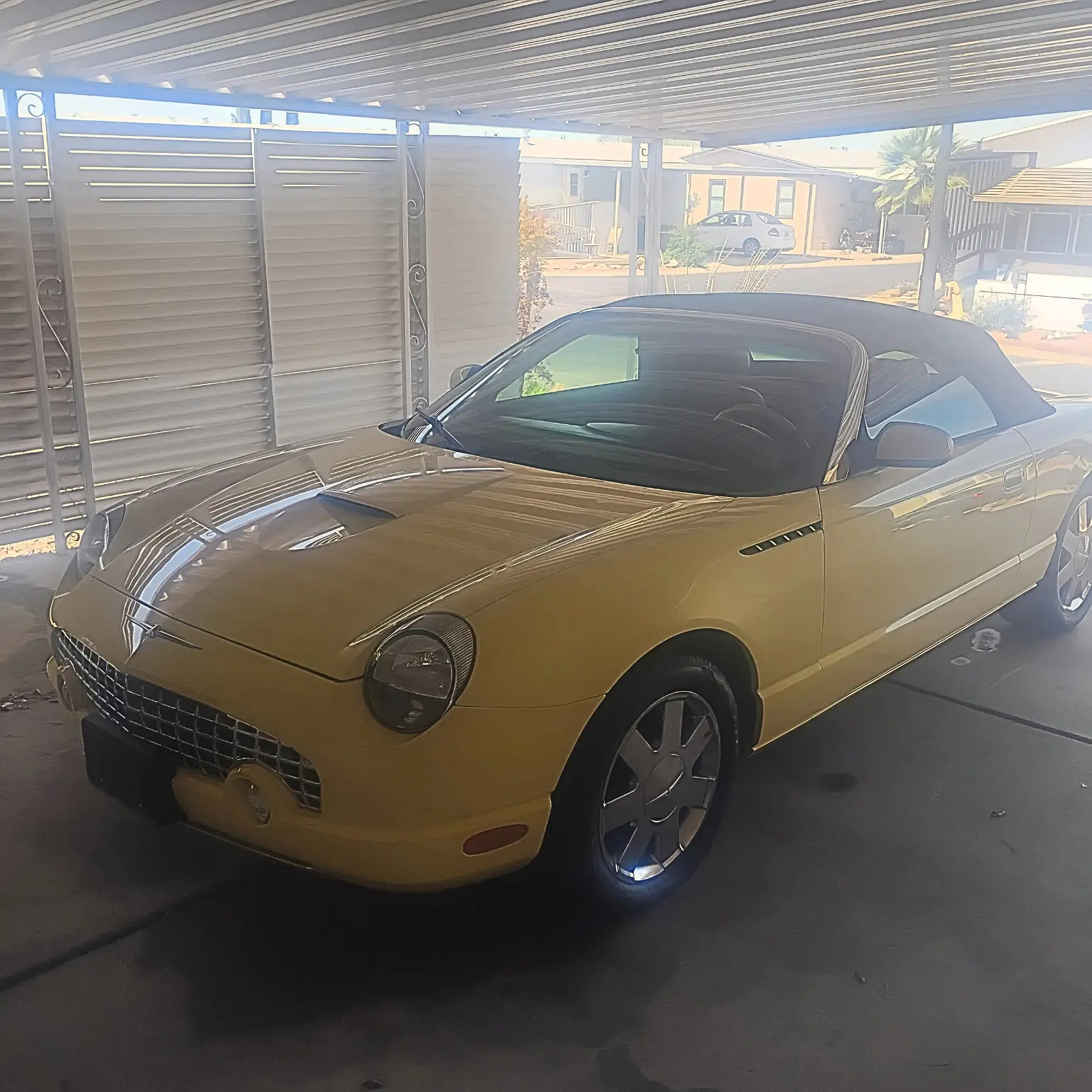 Yellow Ford Thunderbird polished under covered parking