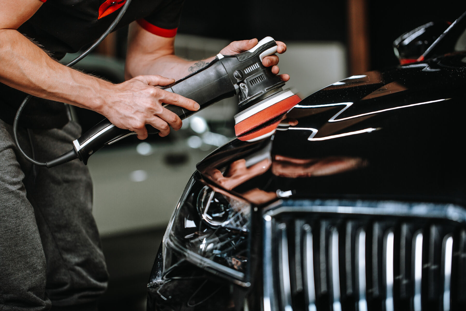 Polisher pad correcting red car paint