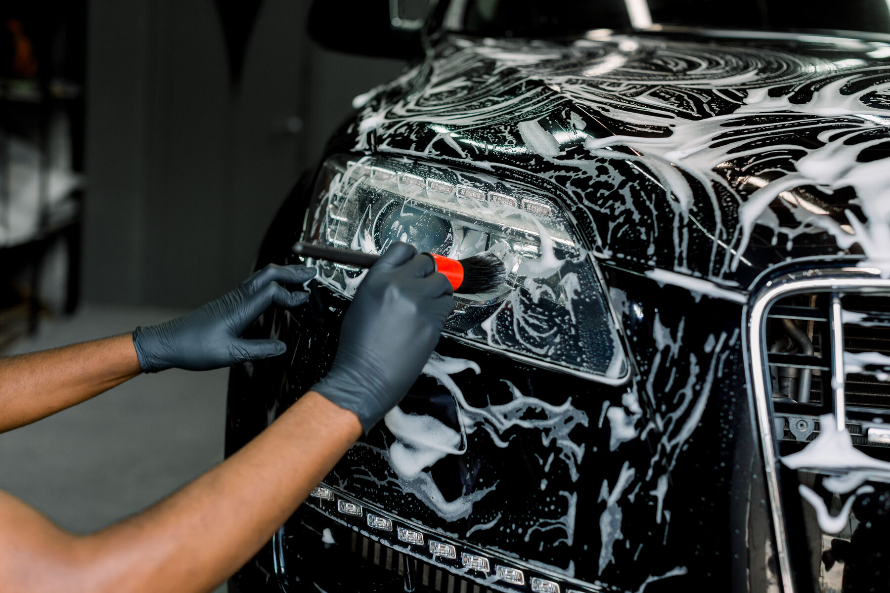 Microfiber mitt washing a wet truck panel